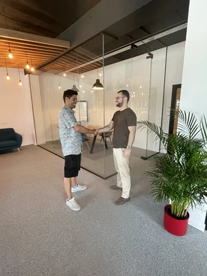 An image of Kim Berthonneau shaking a client's hand